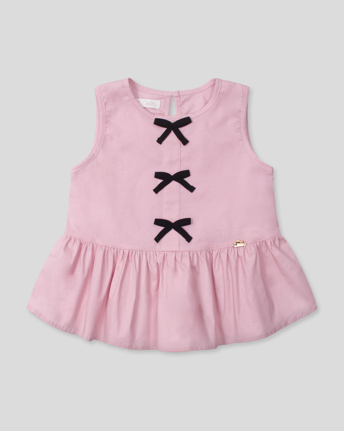 Blusa rosa con moños negros para niña