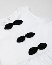Blusa blanca con moños negros para niña