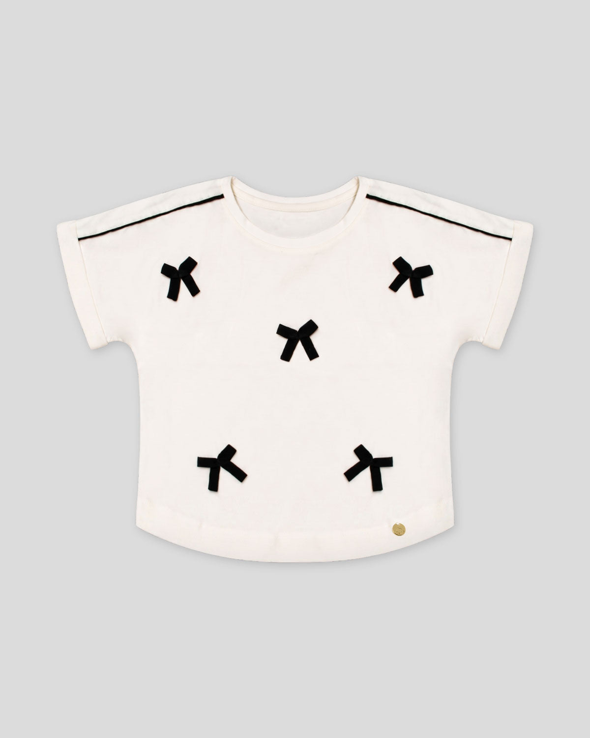 Blusa blanca con moñitos para niña