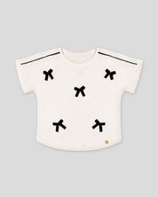 Blusa blanca con moñitos para niña