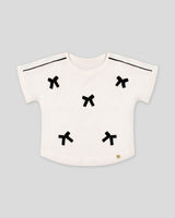 Blusa blanca con moñitos para niña