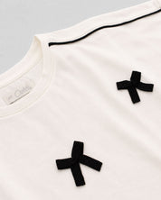 Blusa blanca con moñitos para niña