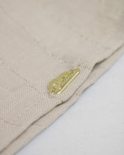 Blusa beige con botones y moñitos para niña