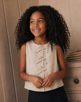 Blusa beige con botones y moñitos para niña