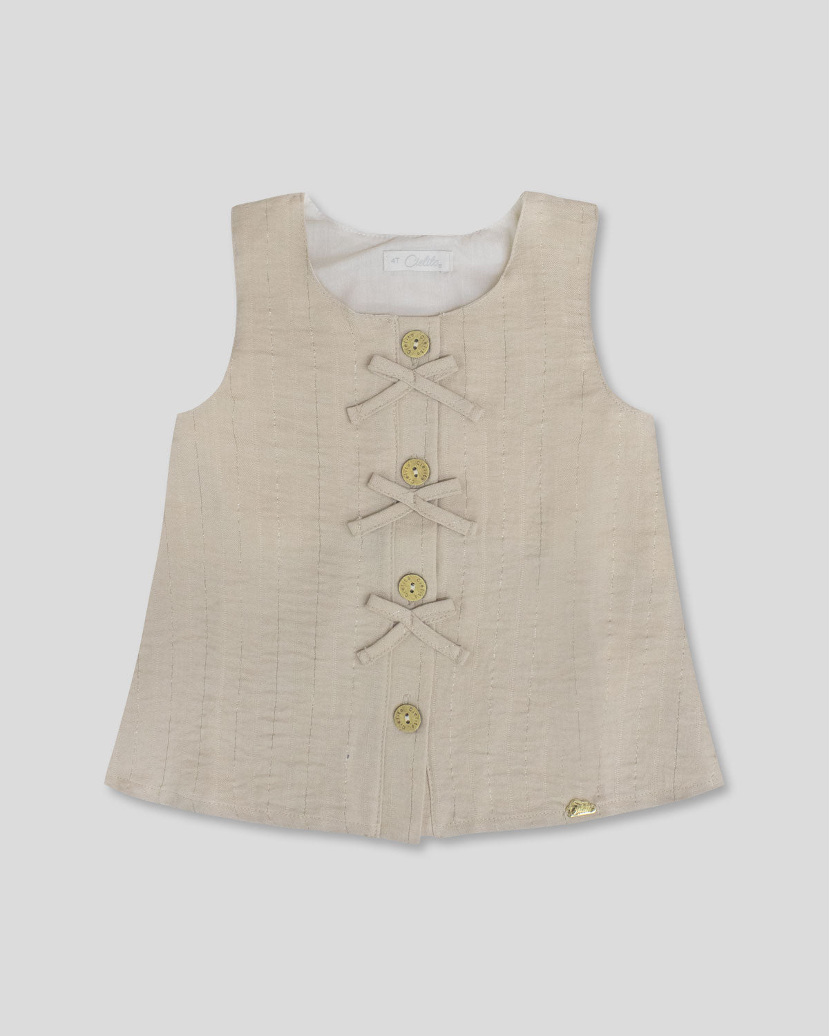Blusa  beige con botones y moñitos para niña
