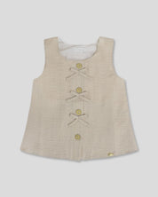 Blusa  beige con botones y moñitos para niña