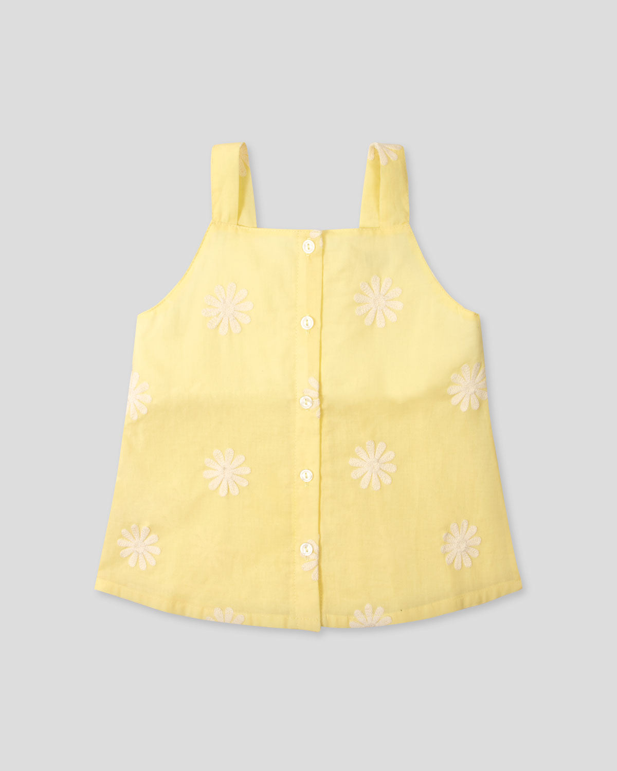 Blusa amarilla de tiras con bordados de flores y botonadura en espalda para niña
