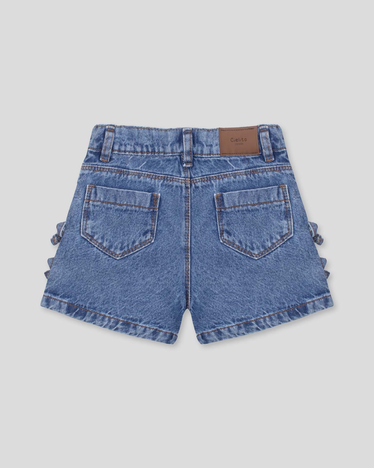 Short denim con moñitos en costados para niña