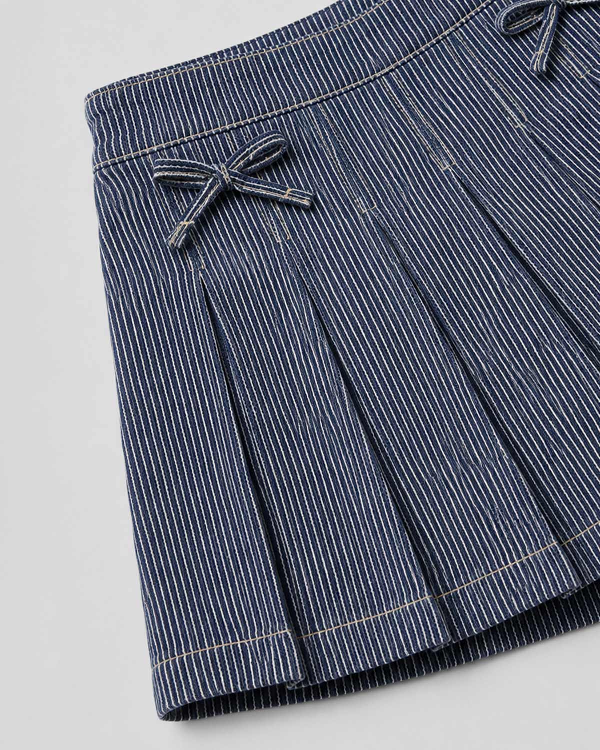 Falda short denim de rayas con moñitos para niña