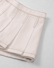 Falda short cruda con pliegues para niña
