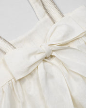 Vestido en lino con textura tejida y moño en espalda para niña