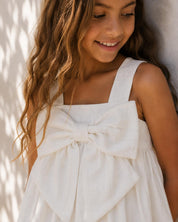 Vestido blanco con moño y líneas plateadas para niña