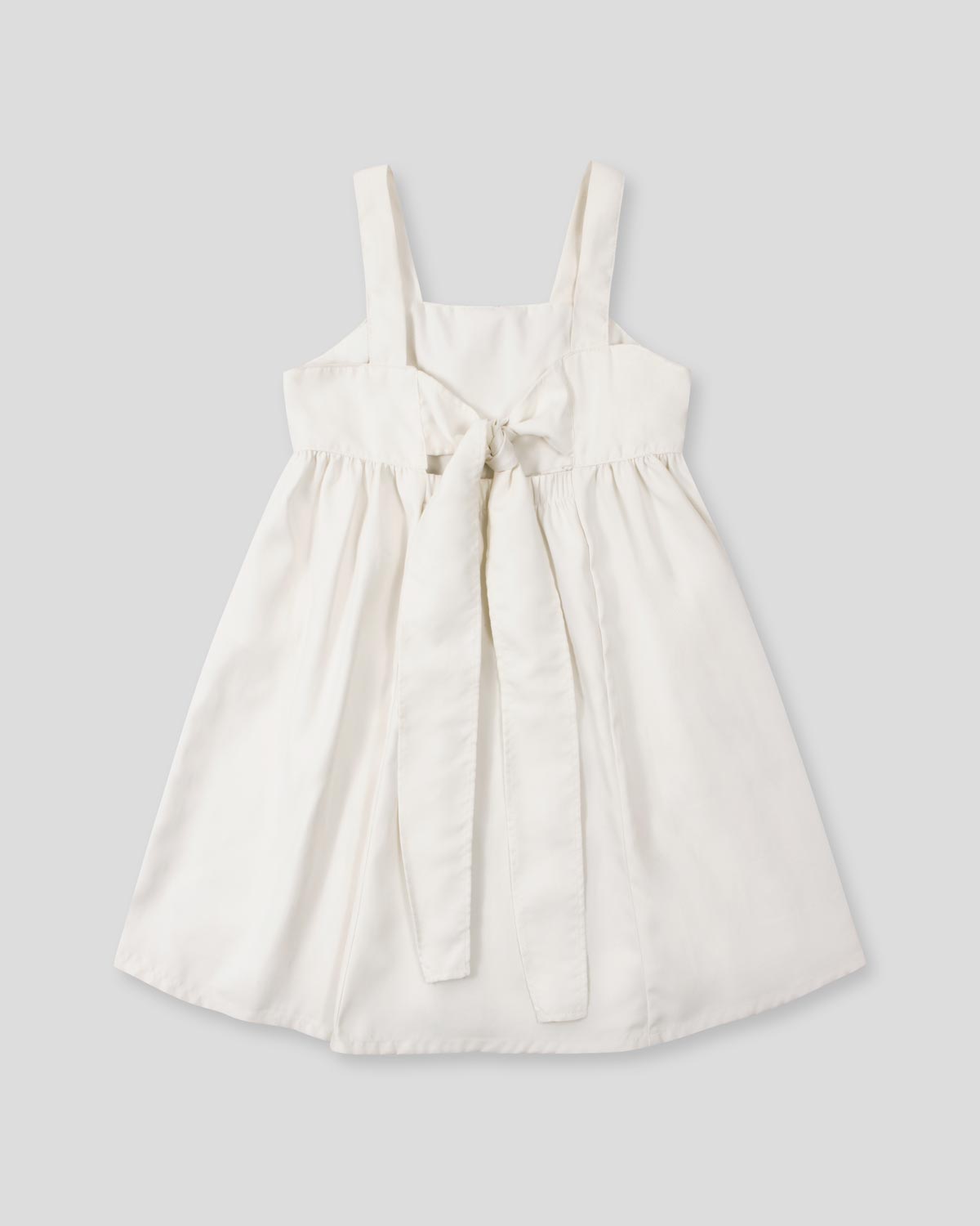 Vestido de tiras con textura tejida y lazos en espalda para niña