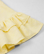 Vestido amarillo con moños y estampado floral para niña
