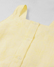 Vestido amarillo con moños y estampado floral para niña
