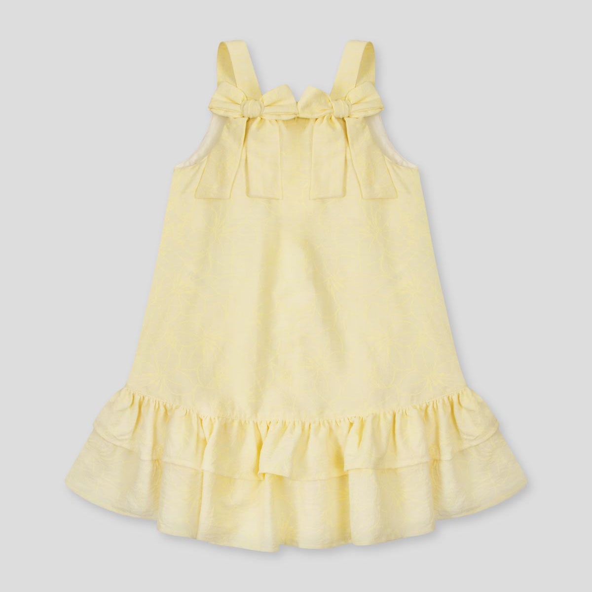Vestido amarillo con moños y estampado floral para niña