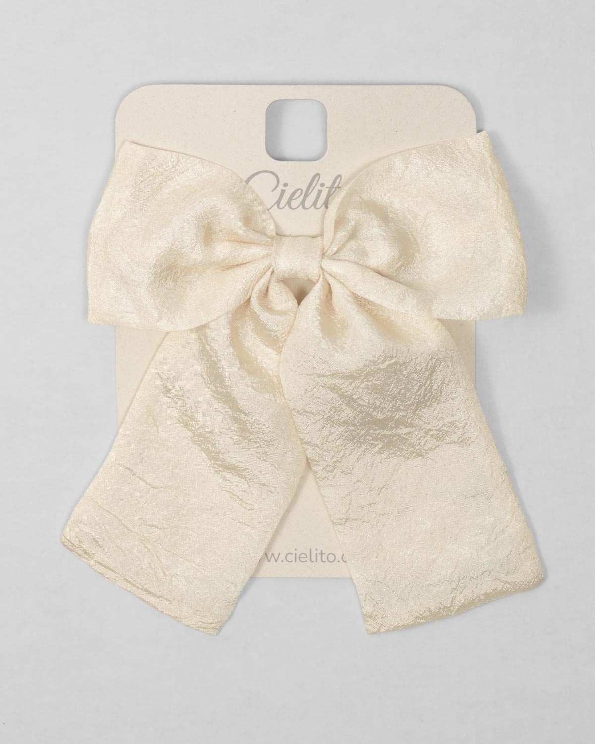 Moño pinza en seda amarillo crema para niña