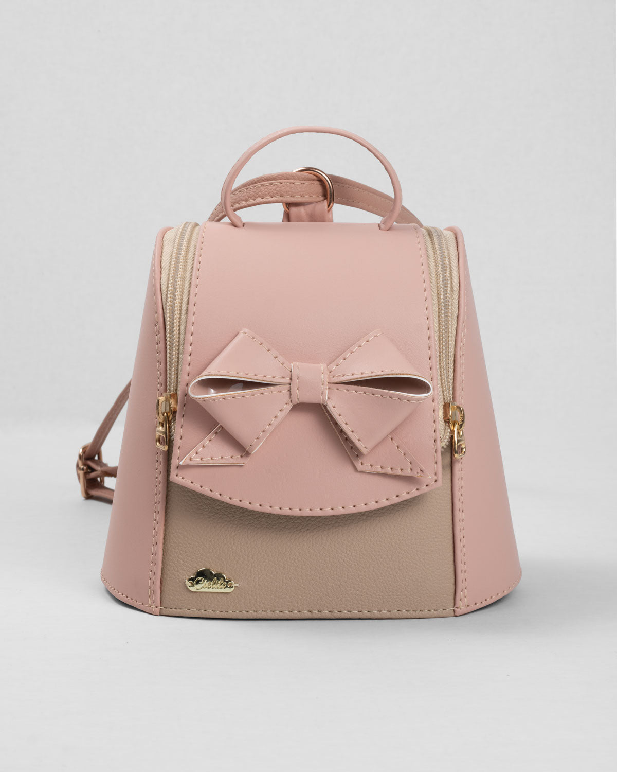 Bolso tipo mochila rosa con detalle de moño y cierre para niña