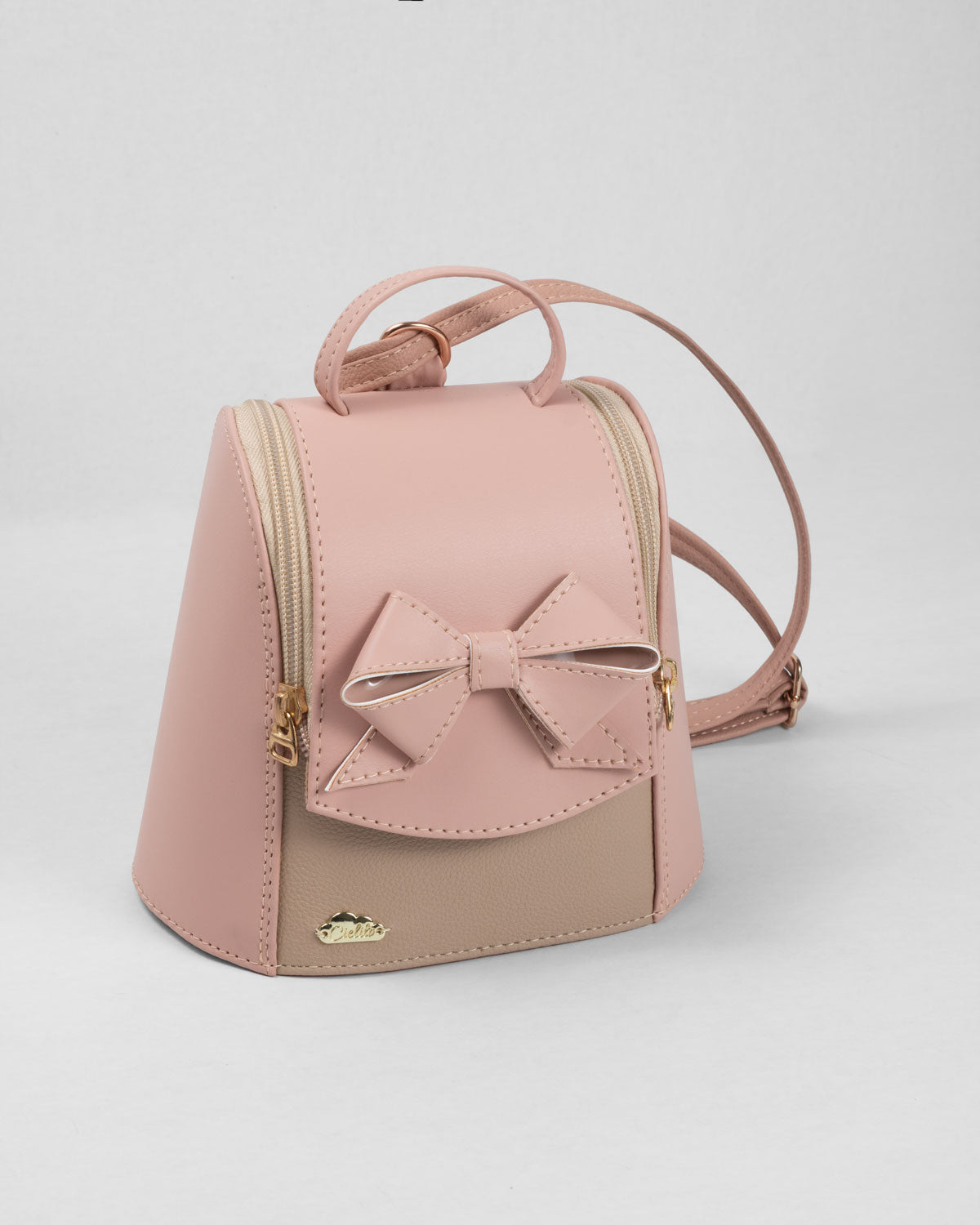 Bolso tipo mochila rosa con detalle de moño y cierre para niña