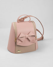 Bolso tipo mochila rosa con detalle de moño y cierre para niña