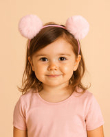Diadema rosa con pompones para niña