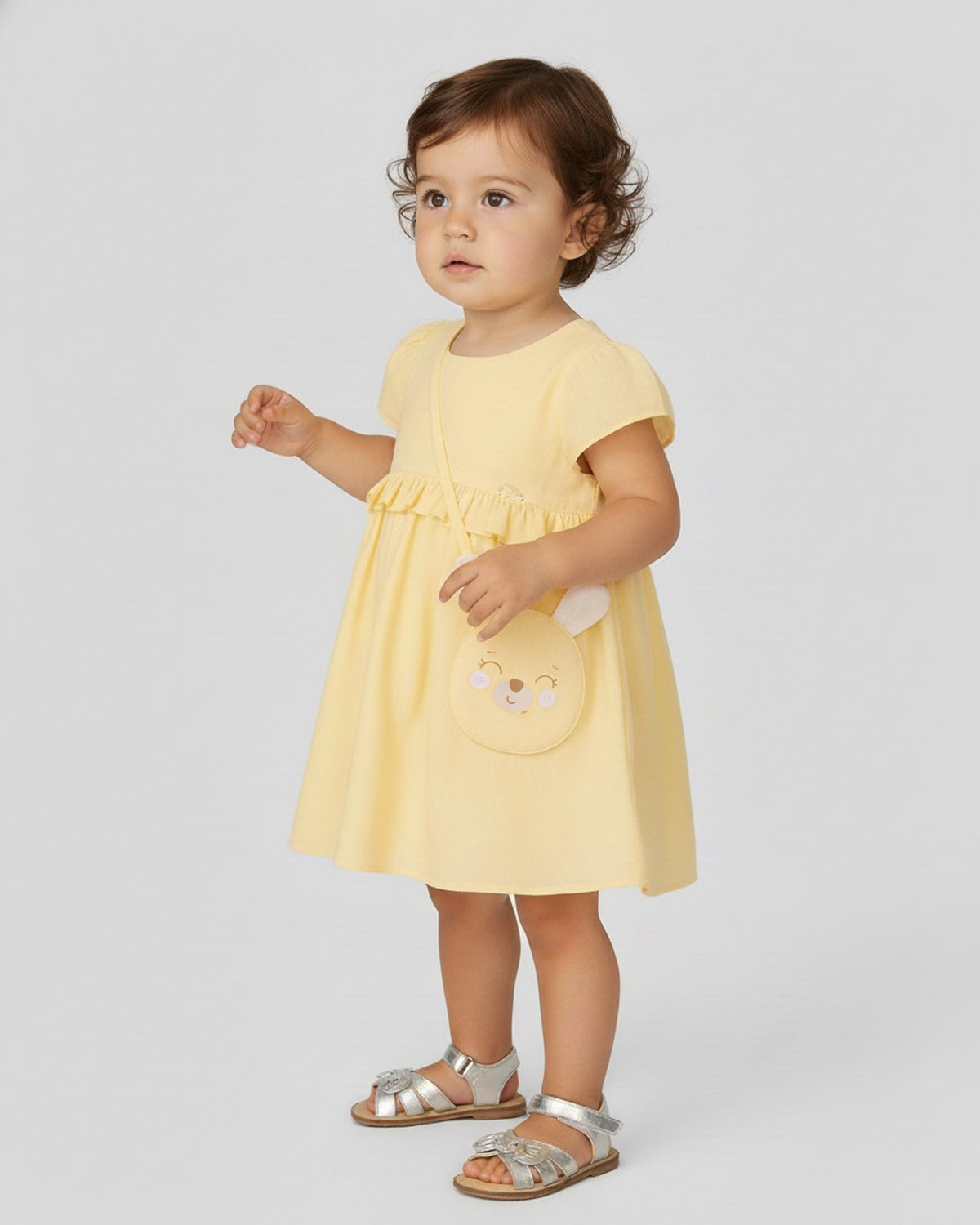Vestido body en lino amarillo con osito tipo bolso para bebé niña