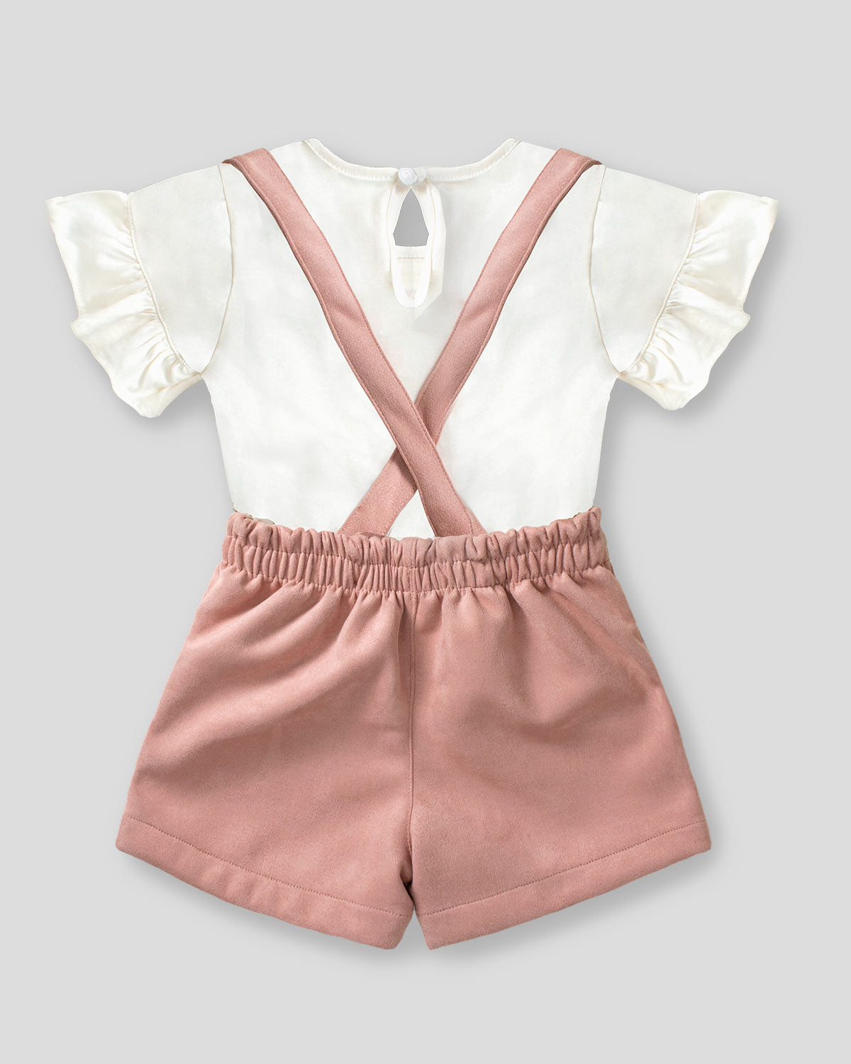 Overol palo de rosa con camiseta beige para niña