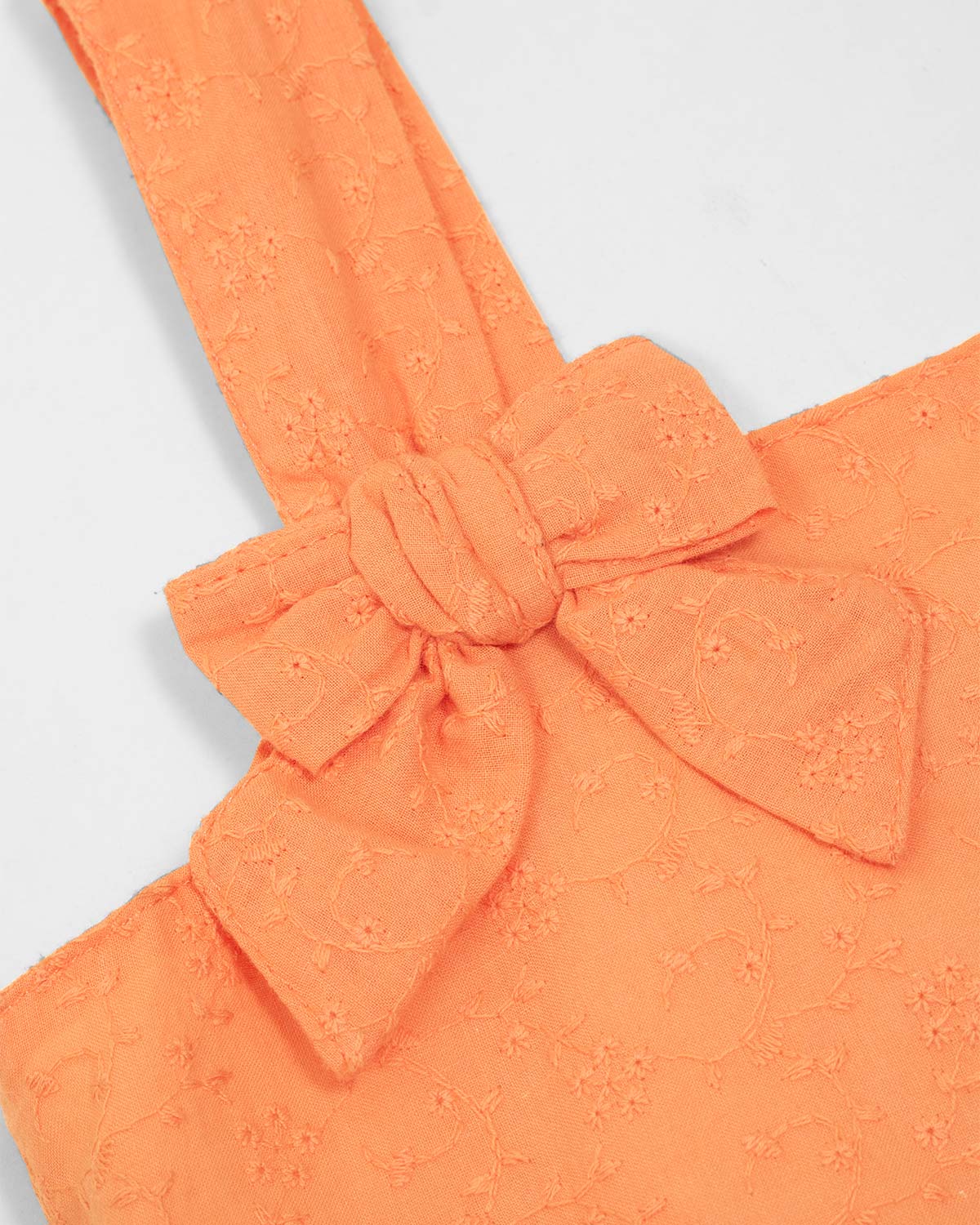 Blusa de tiras naranja con moño para niña