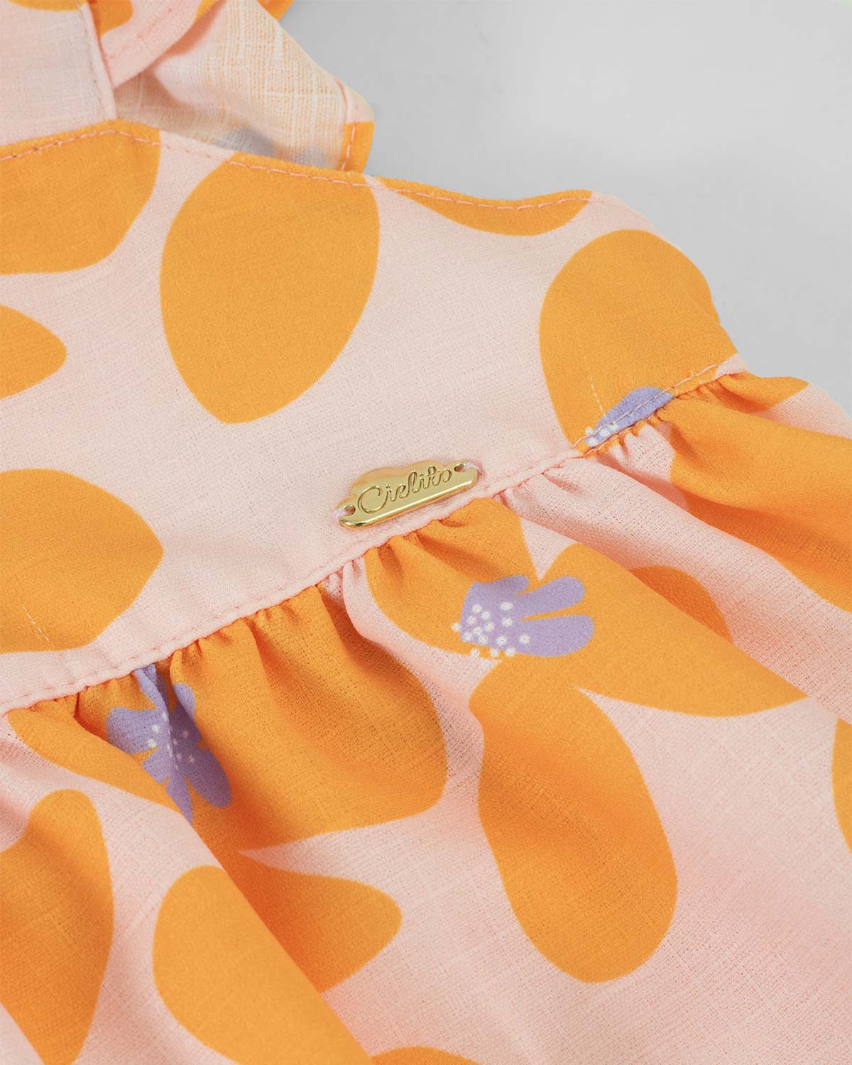 Blusa de flores naranja con boleros en tiras para bebé niña