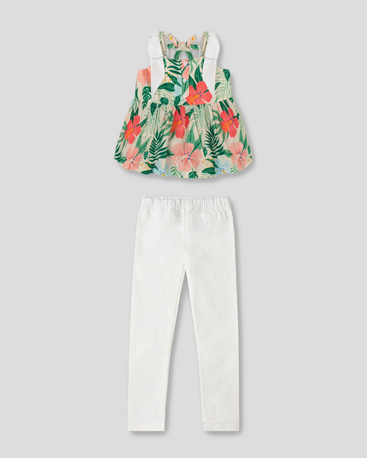 Conjunto blusa de tiras con estampado tropical y leggins blanco para niña